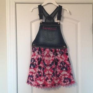 Pink tie-dye denim overalls dress.